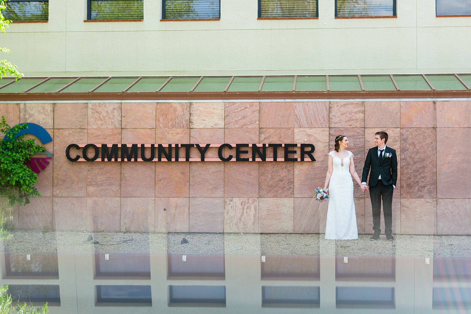 Bride and groom pose for their Chandler Community Center wedding by Chandler wedding photographer PMA Photography.