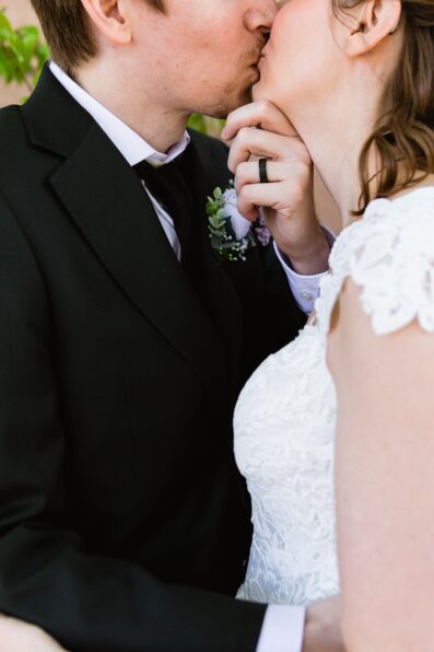 Bride and groom share a kiss during their Chandler Community Center wedding by Chandler wedding photographer PMA Photography.