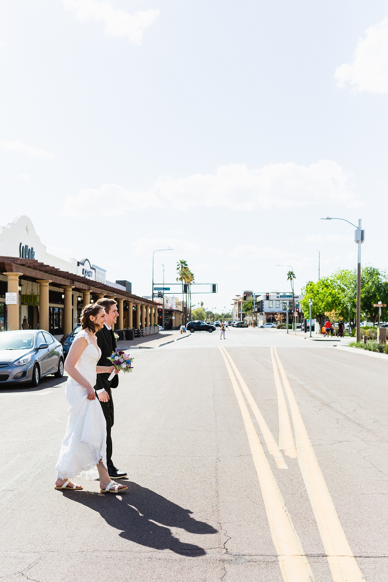 Bride and groom walking together during their Chandler Community Center wedding by Chandler wedding photographer PMA Photography.