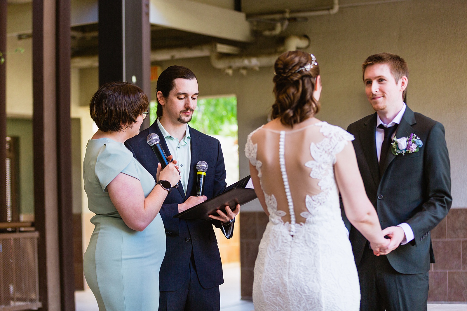 Groom looking at his bride during their wedding ceremony at Chandler Community Center by Chandler wedding photographer PMA Photography.