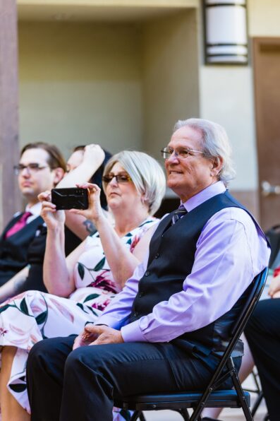Wedding guests watching the wedding ceremony at Chandler Community Center by Chandler wedding photographer PMA Photography.