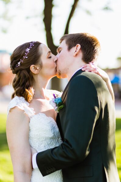 Bride and groom share a kiss during their Chandler Community Center wedding by Arizona wedding photographer PMA Photography.