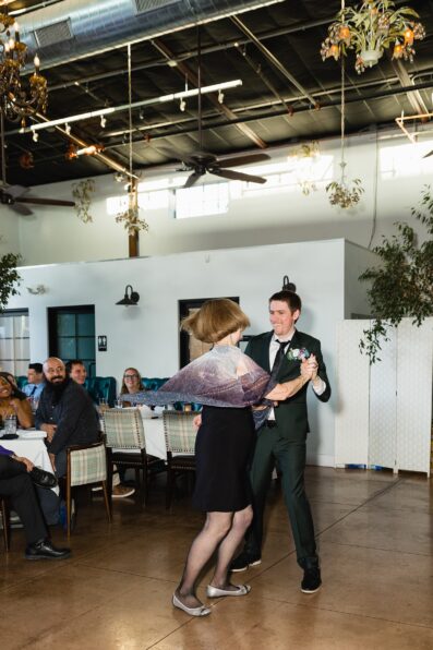 Groom dancing with guests at Hidden House wedding reception by Chandler wedding photographer PMA Photography