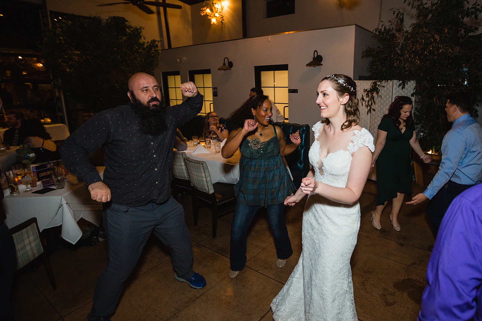 Bride dancing with guests at Hidden House wedding reception by Chandler wedding photographer PMA Photography