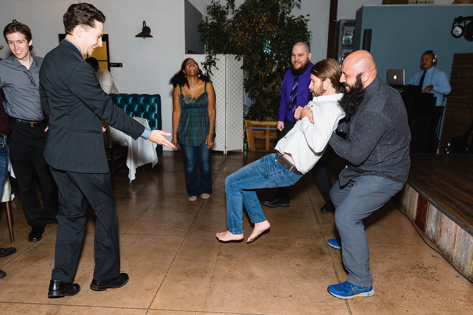 Guests dancing together at Hidden House wedding reception by Chandler wedding photographer PMA Photography