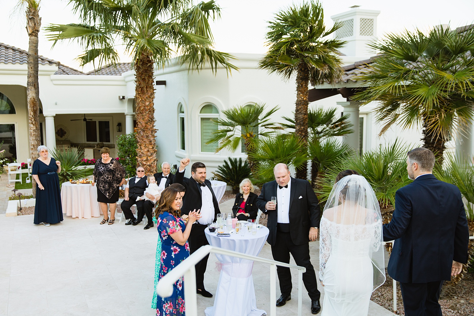 Couple's grand entrance at backyard wedding reception by Scottsdale wedding photographer PMA Photography.
