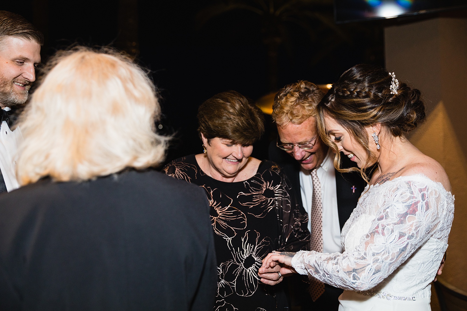 Bride with guests at backyard wedding reception by Scottsdale wedding photographer PMA Photography