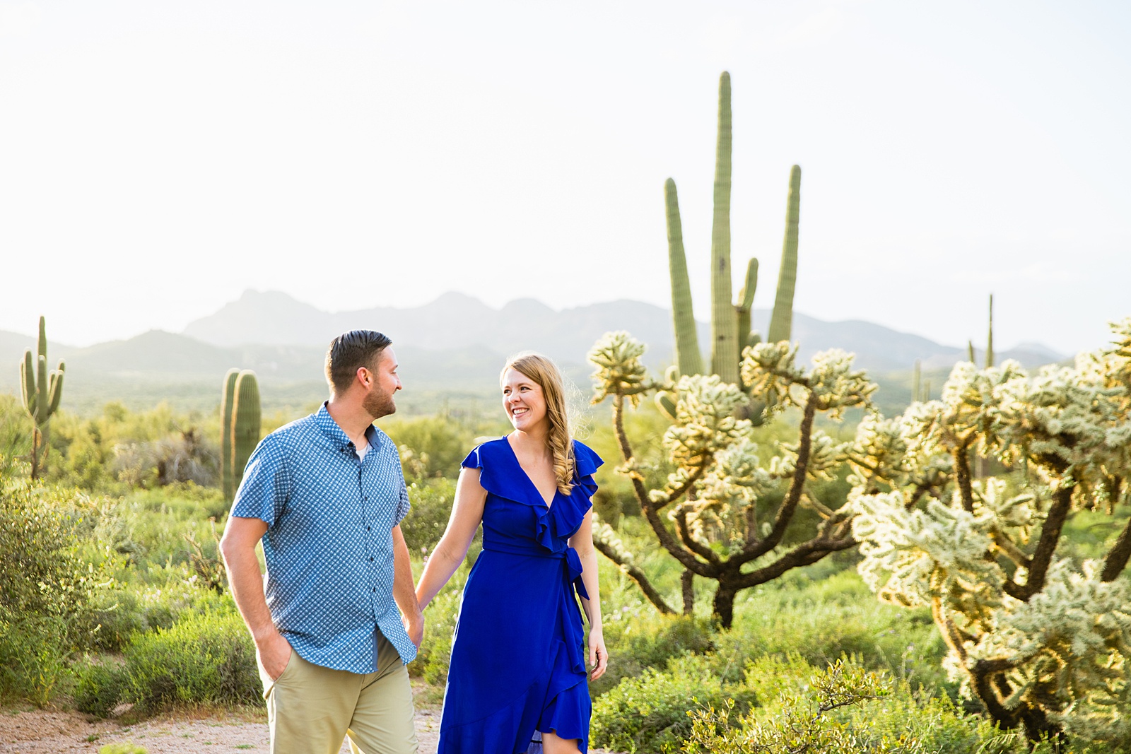 Couple look at each other during their Apache Junction engagement session by Arizona wedding photographer PMA Photography.
