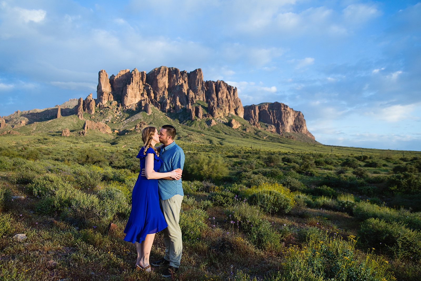 Couple share a kiss during their Apache Junction engagement session by Arizona wedding photographer PMA Photography.