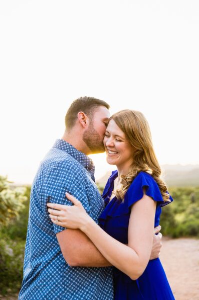 Couple laugh together during their Superstitions Mountain engagement session by Apache Junction engagement photographer PMA Photography.Couple laugh together during their Superstitions Mountain engagement session by Apache Junction engagement photographer PMA Photography.
