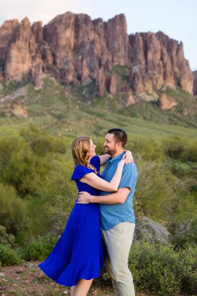 Couple pose for their Superstitions Mountain engagement session by Apache Junction wedding photographer PMA Photography.