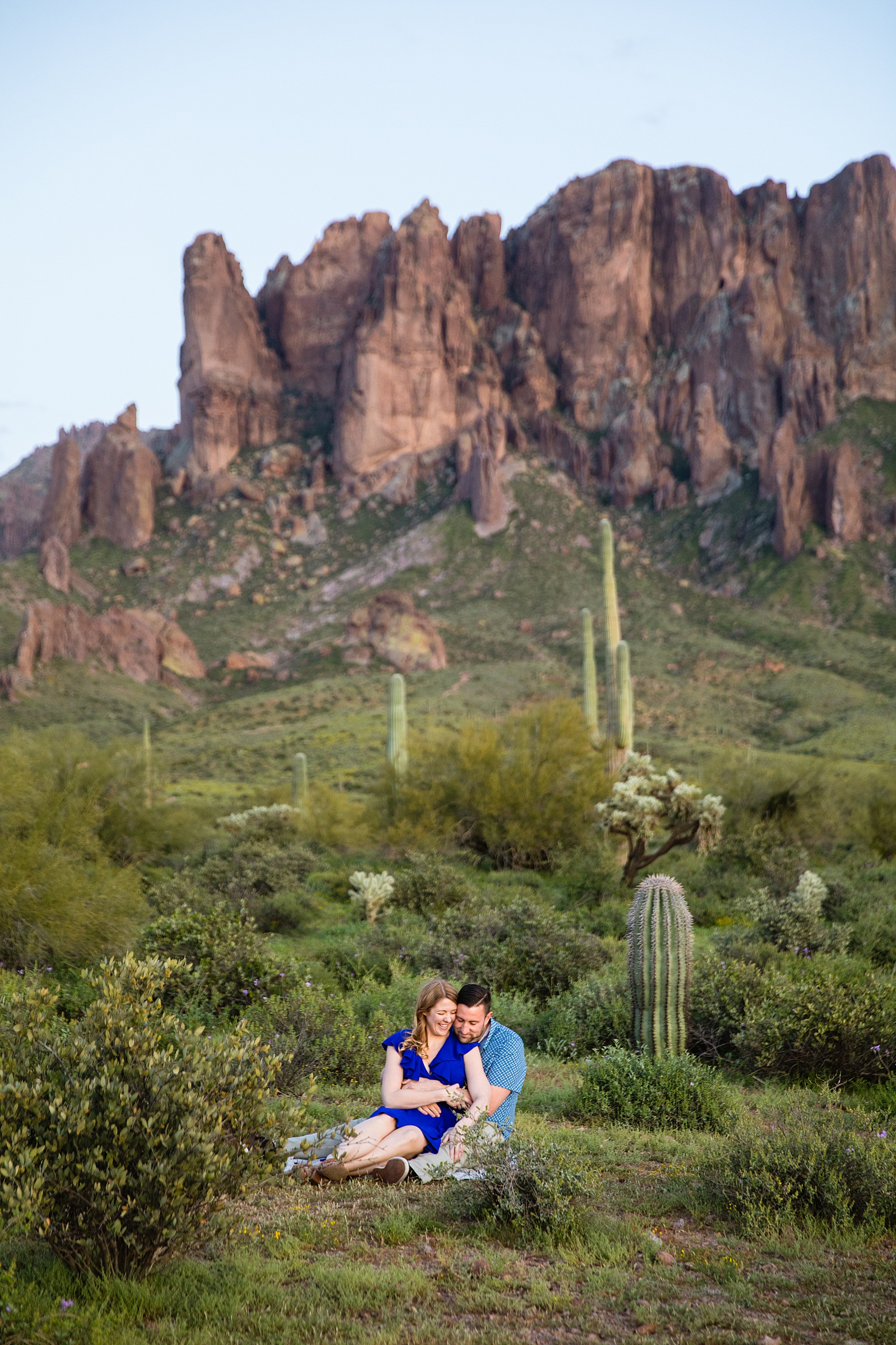 Couple share an intimate moment during their Superstitions Mountain engagement session by Apache Junction engagement photographer PMA Photography.