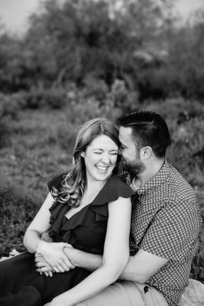 Couple laugh together during their Superstitions Mountain engagement session by Apache Junction engagement photographer PMA Photography.