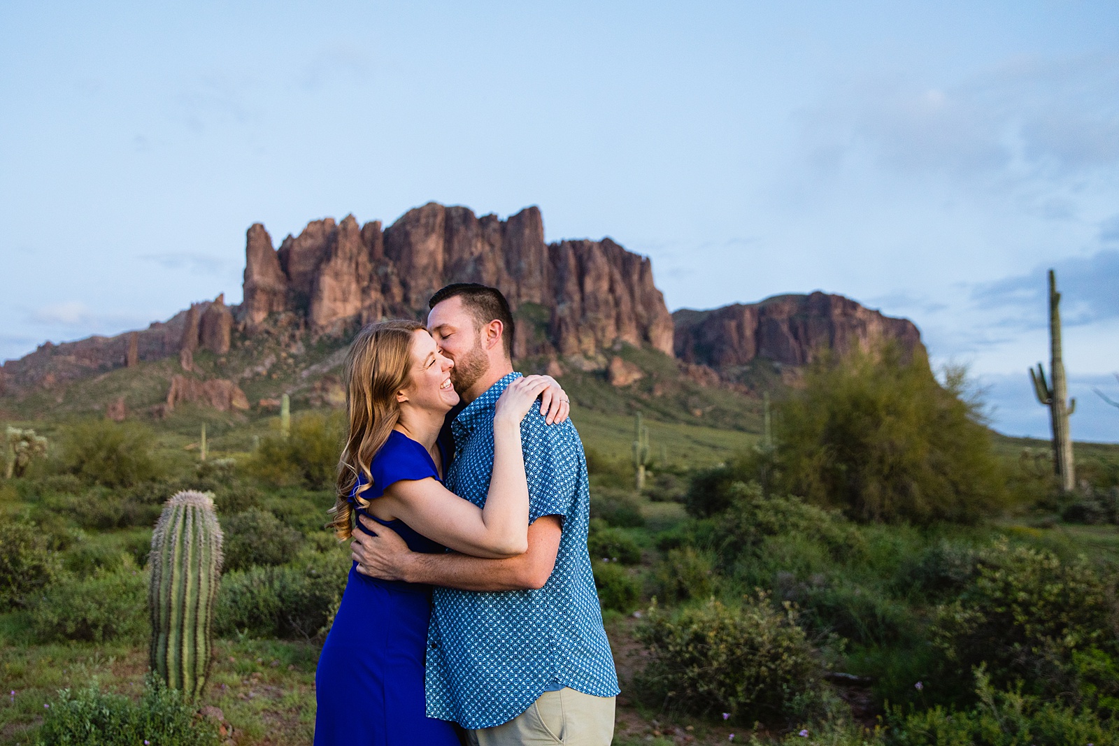 Couple laugh together during their Superstitions Mountain engagement session by Apache Junction engagement photographer PMA Photography.