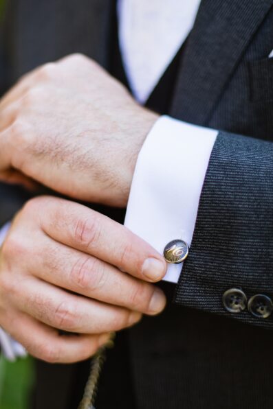Groom adjusting his cufflinks for his wedding day by Phoenix wedding photographers PMA Photography.