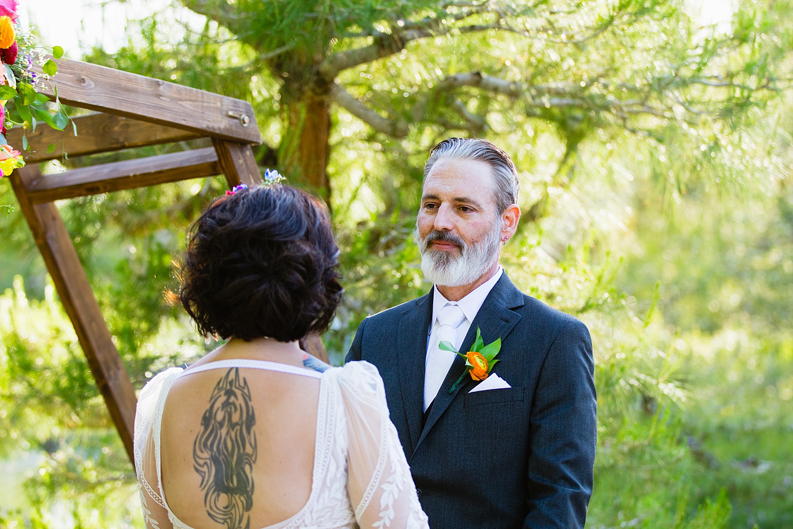 Groom looking at his bride during their wedding ceremony at Japanese Friendship Garden by Phoenix wedding photographer PMA Photography.