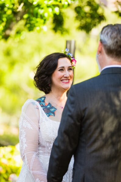 Bride looking at her groom during their wedding ceremony at Japanese Friendship Garden by Phoenix wedding photographer PMA Photography.