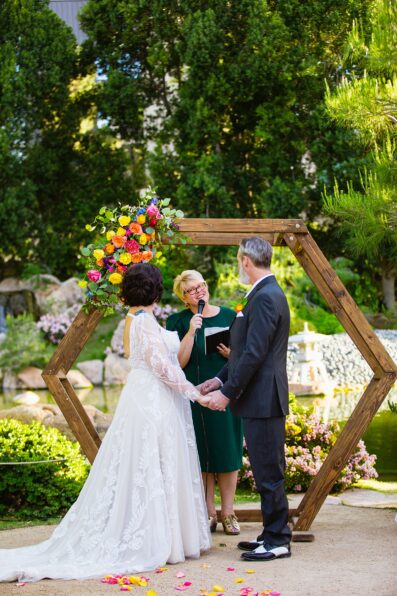Bride and groom exchange vows during their Japanese Friendship Garden wedding ceremony by Phoenix wedding photographer PMA Photography.