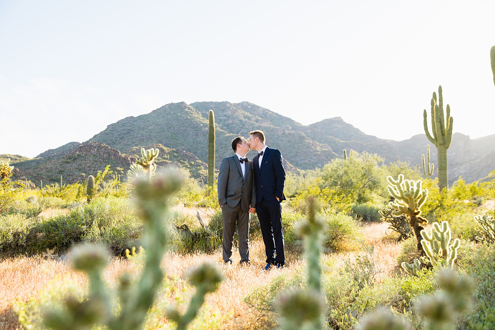 LGBTQ couple share a kiss during their White Tanks elopement by Phoenix elopement photographer PMA Photography.
