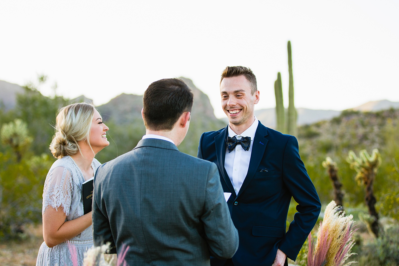 Groom looking at his groom during their wedding ceremony at White Tanks by Phoenix elopement photographer PMA Photography.