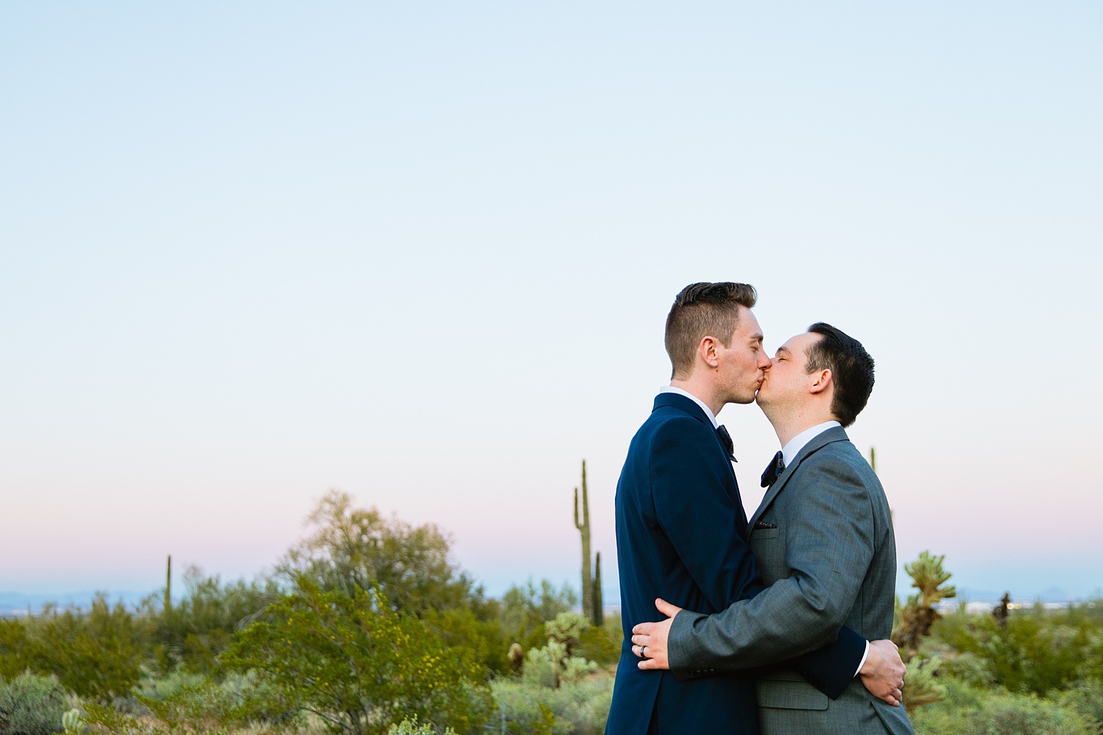 LGBTQ couple share a kiss during their White Tanks elopement by Arizona elopement photographer PMA Photography.