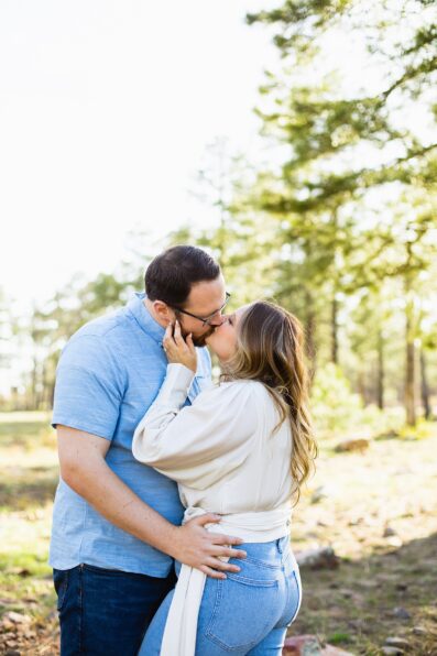 Couple share a kiss during their Mogollon Rim engagement session by Payson wedding photographer PMA Photography.