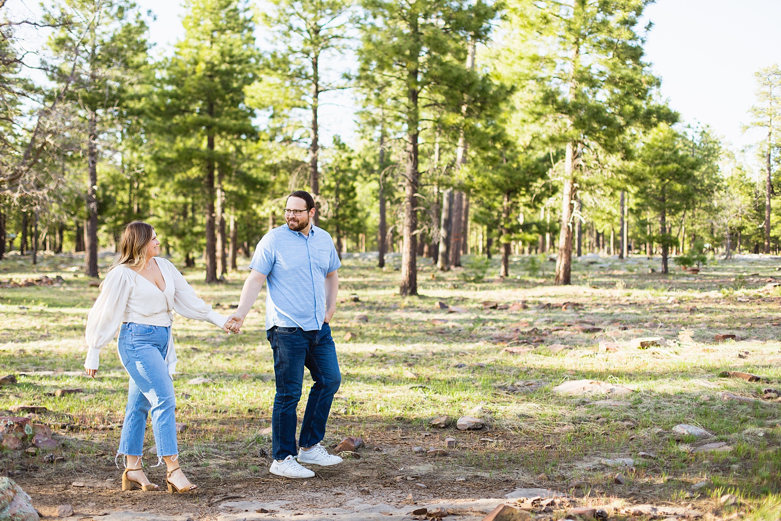 Adventurous couple walking together during their Payson engagement session by Arizona engagement photographer PMA Photography.