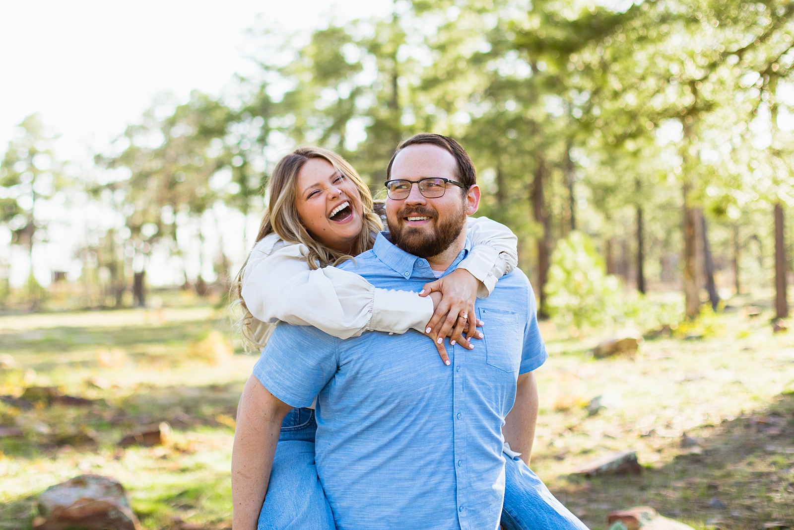 Adventurous couple laugh together during their Mogollon Rim engagement session by Payson engagement photographer PMA Photography.