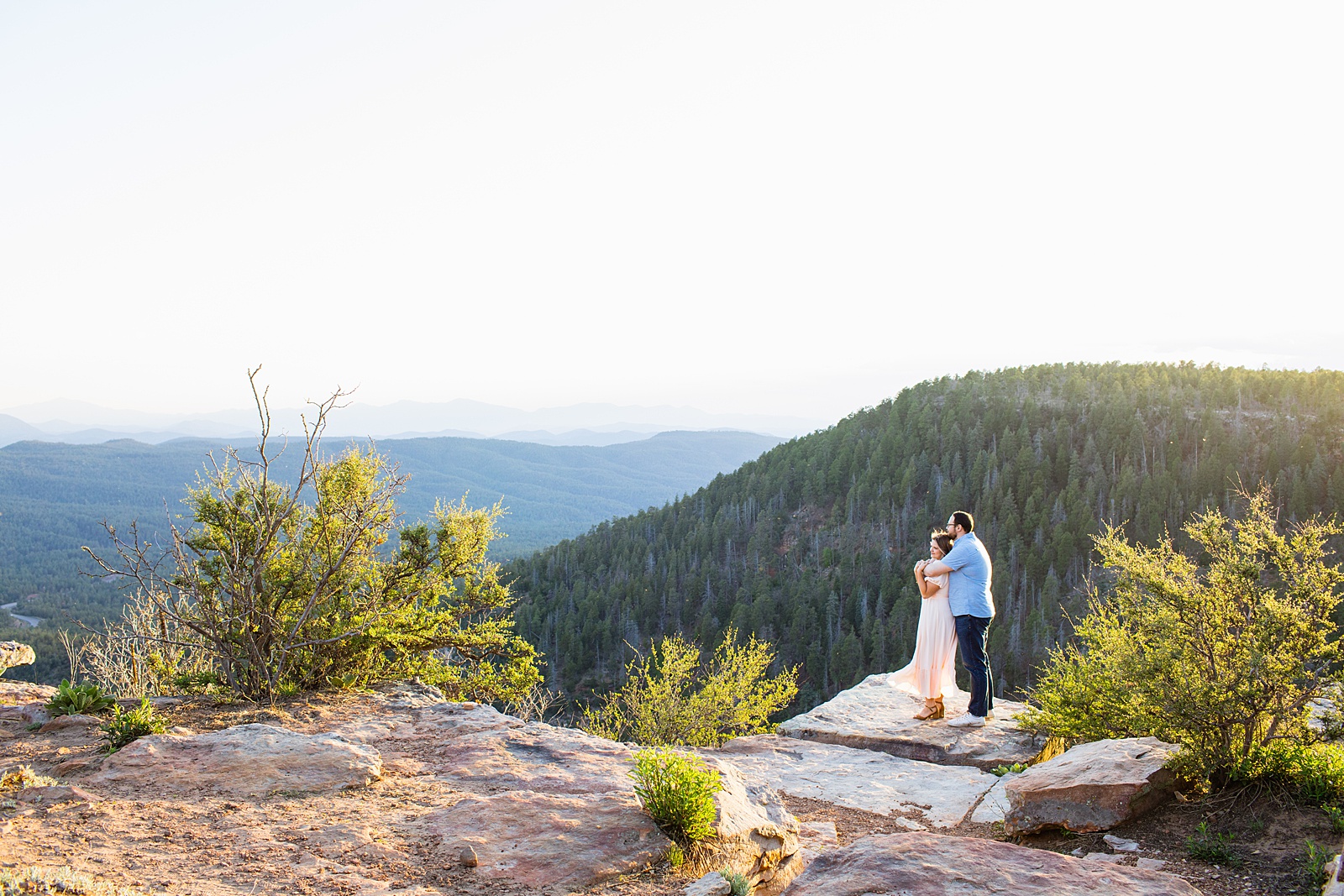 Adventurous couple look out with each other during their Payson engagement session by Arizona wedding photographer PMA Photography.