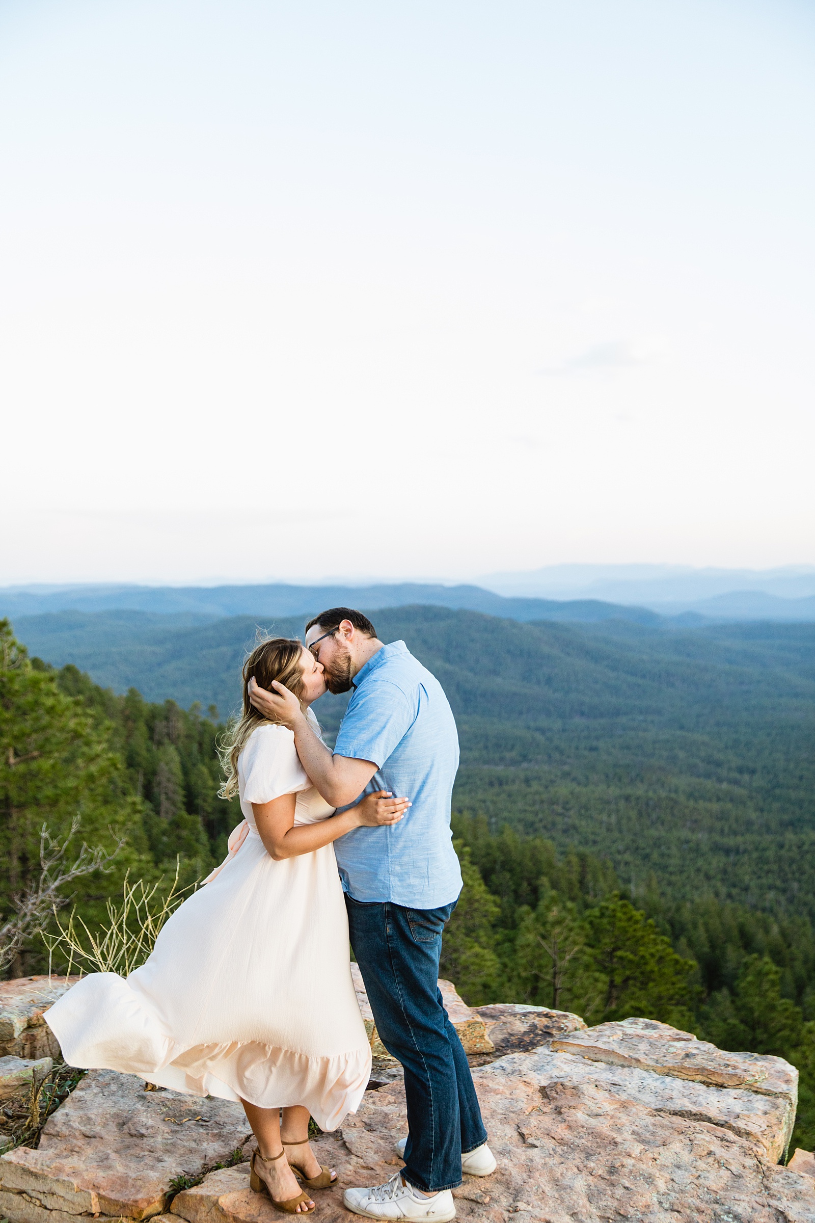 Adventurous couple share a kiss during their Payson engagement session by Arizona wedding photographer PMA Photography.