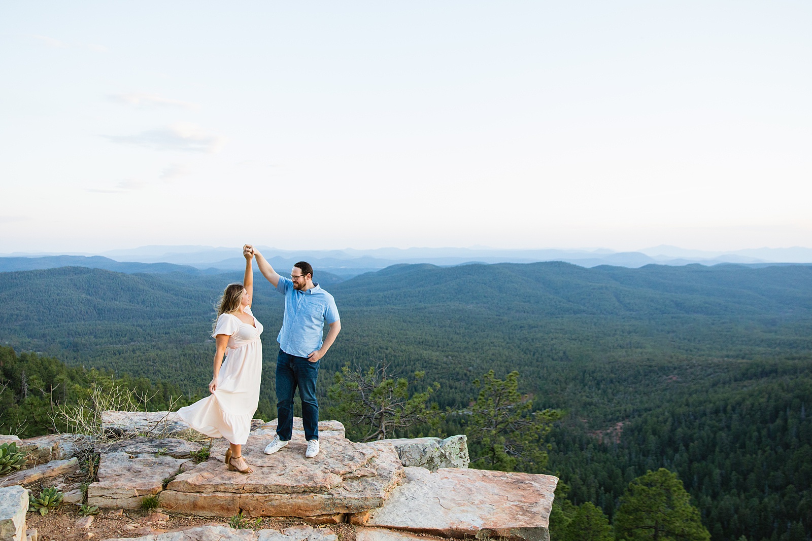 Adventurous couple dance with each other during their Payson engagement session by Arizona wedding photographer PMA Photography.