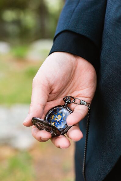 Groom's wedding day details of pocket watch by PMA Photography.