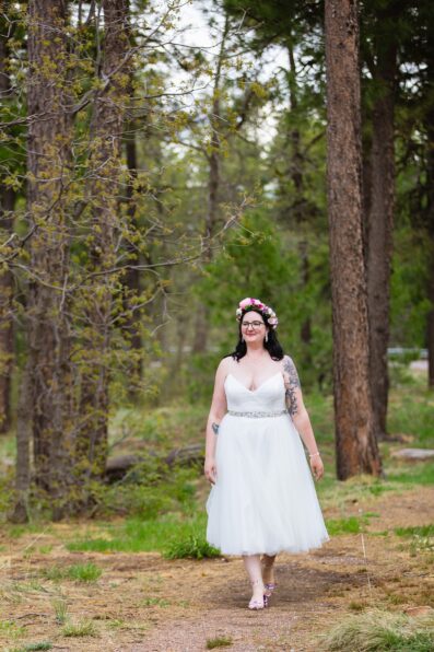 Bride walking down aisle during Mogollon Rim wedding ceremony by Arizona elopement photographer PMA Photography.