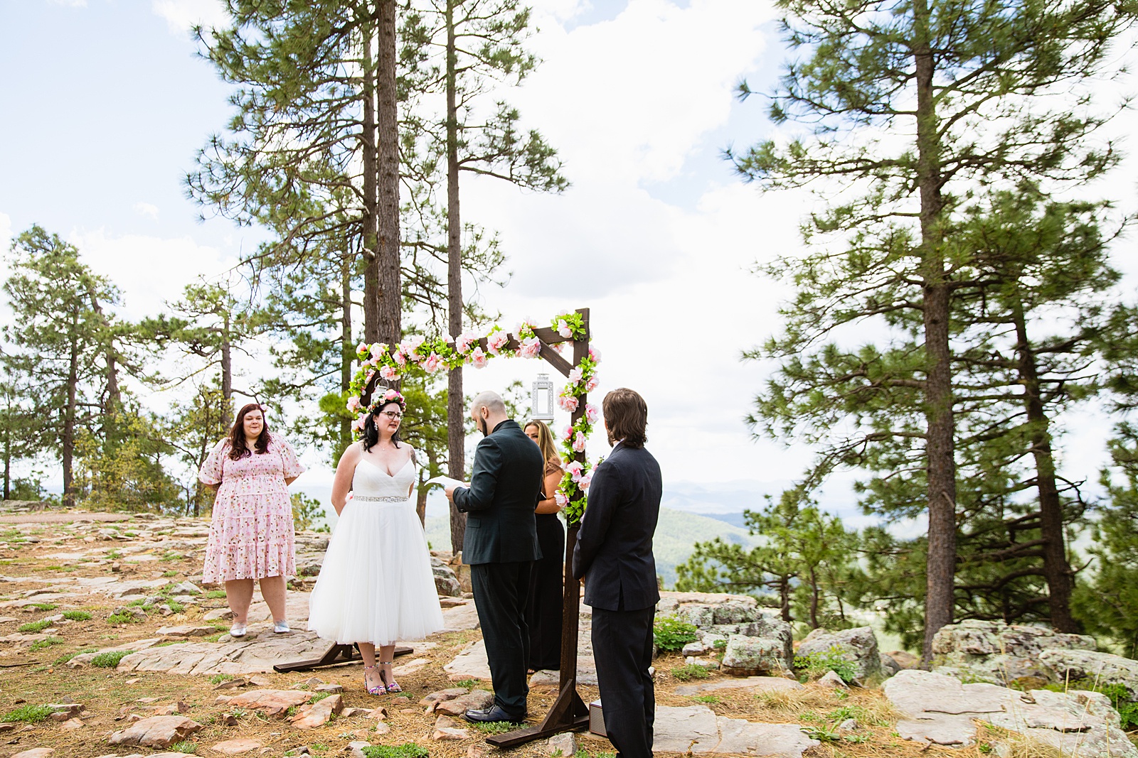 Bride & Groom exchange vows during their wedding ceremony at Mogollon Rim by Arizona elopement photographer PMA Photography.