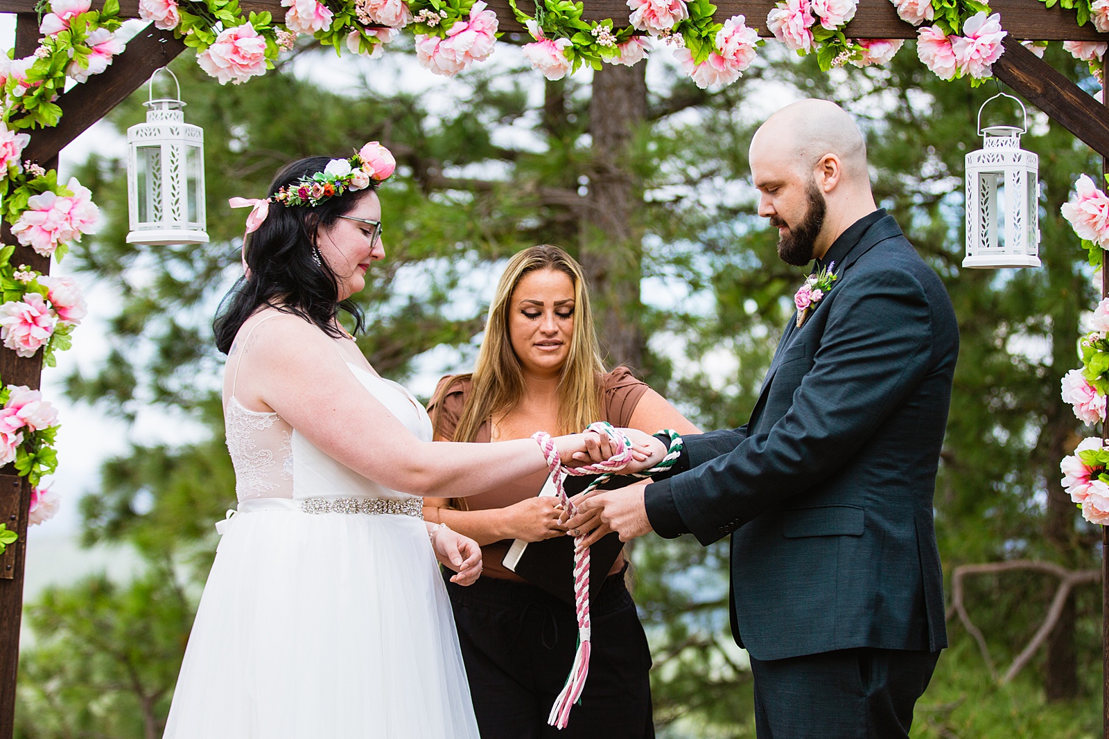 Bride & Groom handfasting togethering during Mogollon Rim wedding ceremony by Payson elopement photographer PMA Photography.
