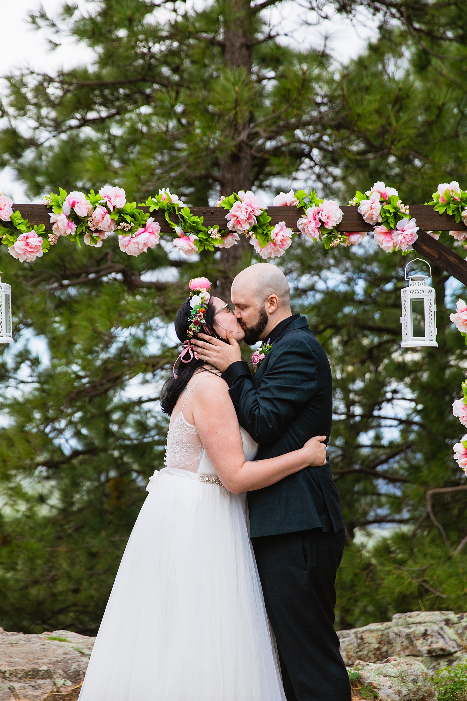 Bride & Groom share their first kiss during their wedding ceremony at Mogollon Rim by Arizona elopement photographer PMA Photography.