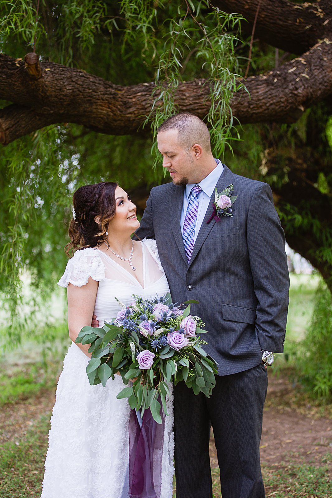 Bride and groom wearing purple and blue colors for their fall Phoenix wedding by PMA Photography.
