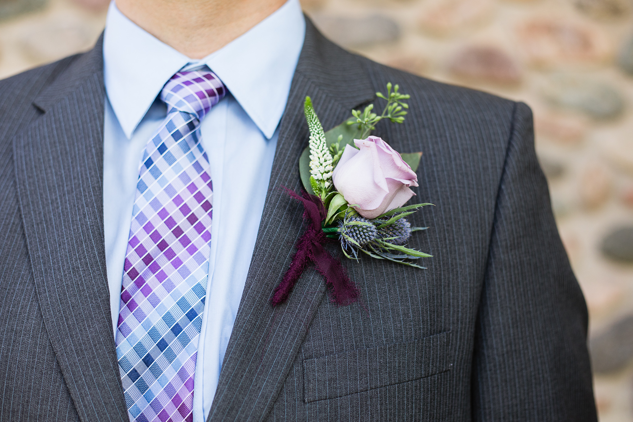 Groom's boutonniere and suit detail by Phoenix wedding photographer PMA Photography.