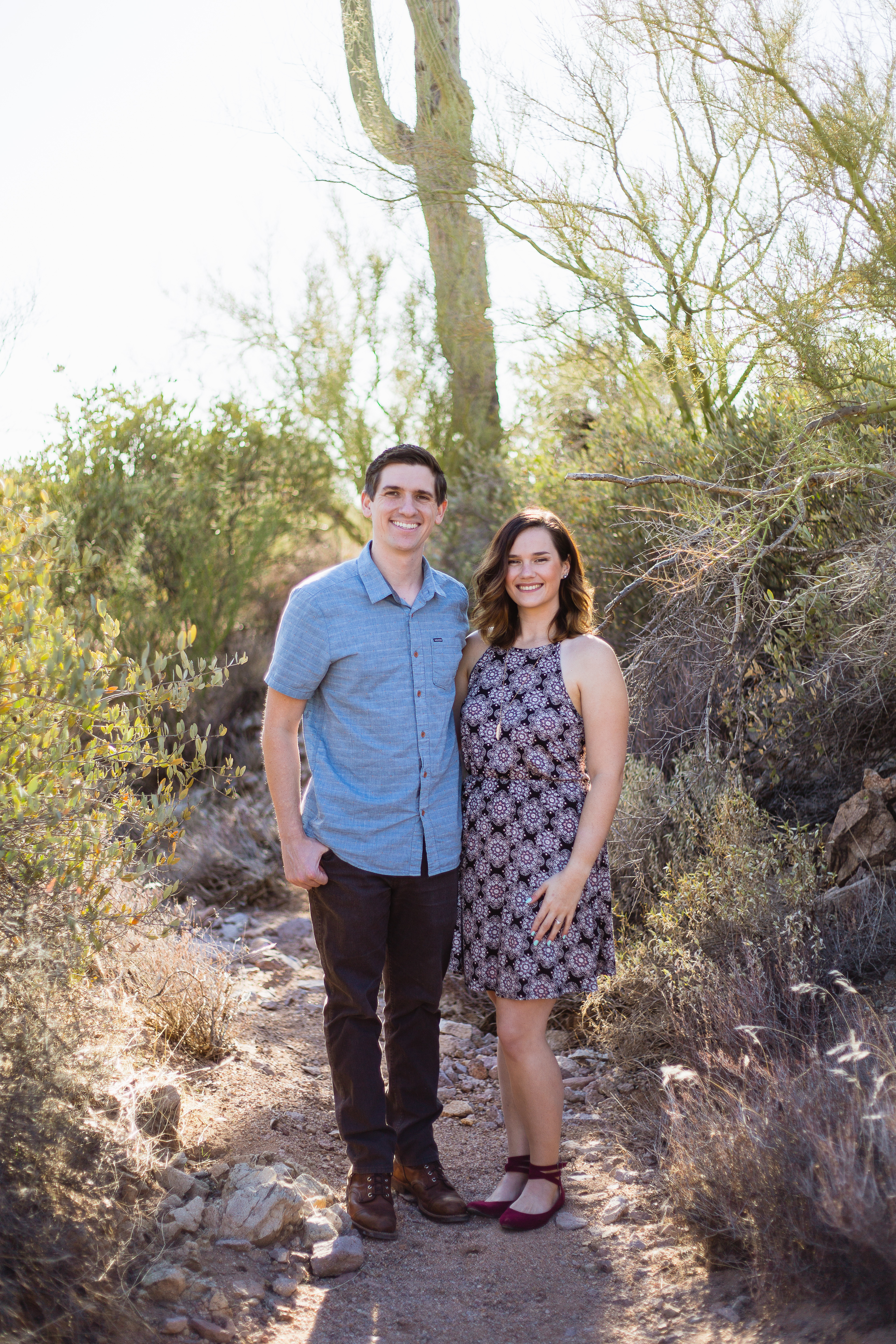 Couple at desert engagement session at Lost Dutchman State Park by wedding photographer PMA Photography.
