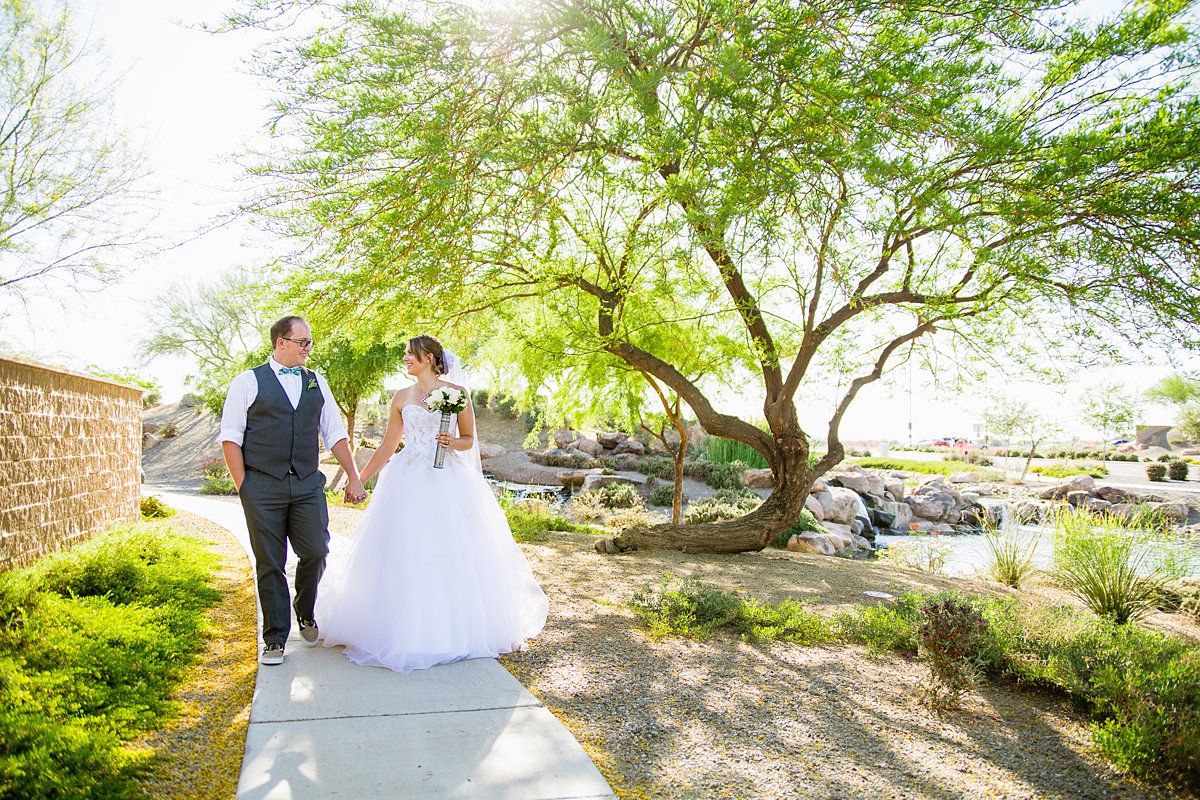 Bride and groom walk together on their wedding day by PMA Photography.