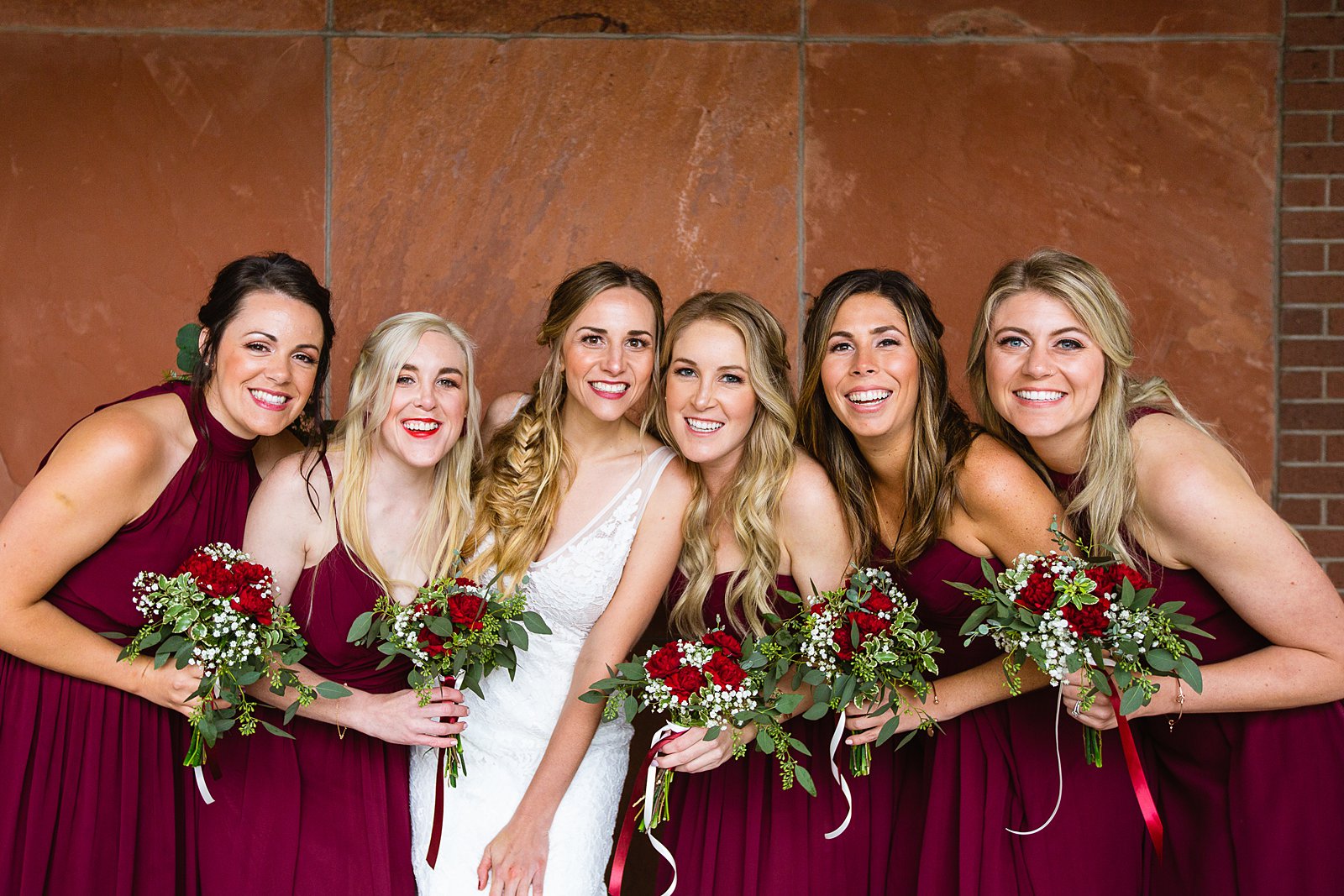 Bride and bridesmaids together at a downtown Flagstaff wedding by Arizona wedding photographer PMA Photography.