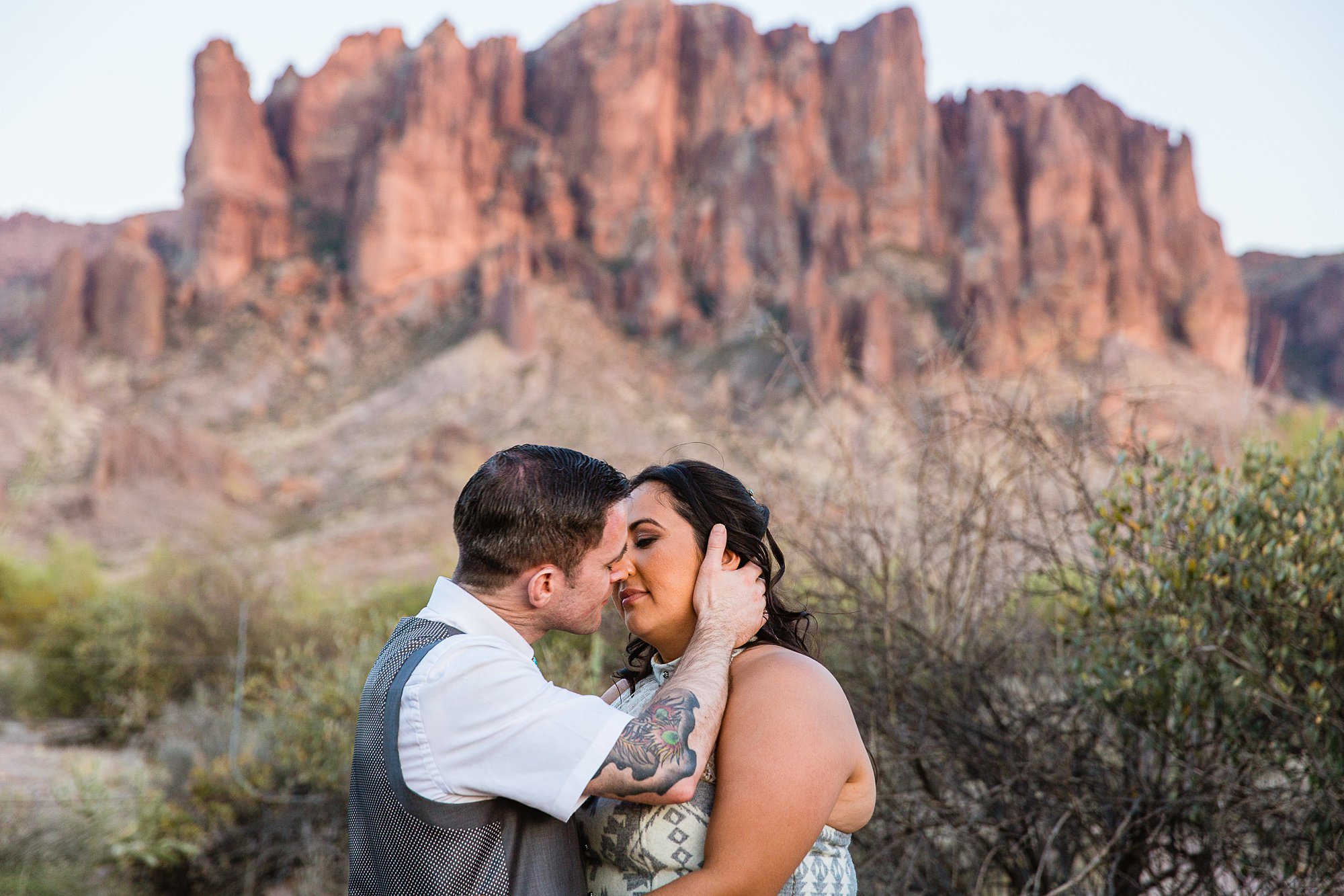 Tattooed groom showing off his sleeves with a tailored short sleeve button up by Arizona Wedding Photographer PMA Photography.