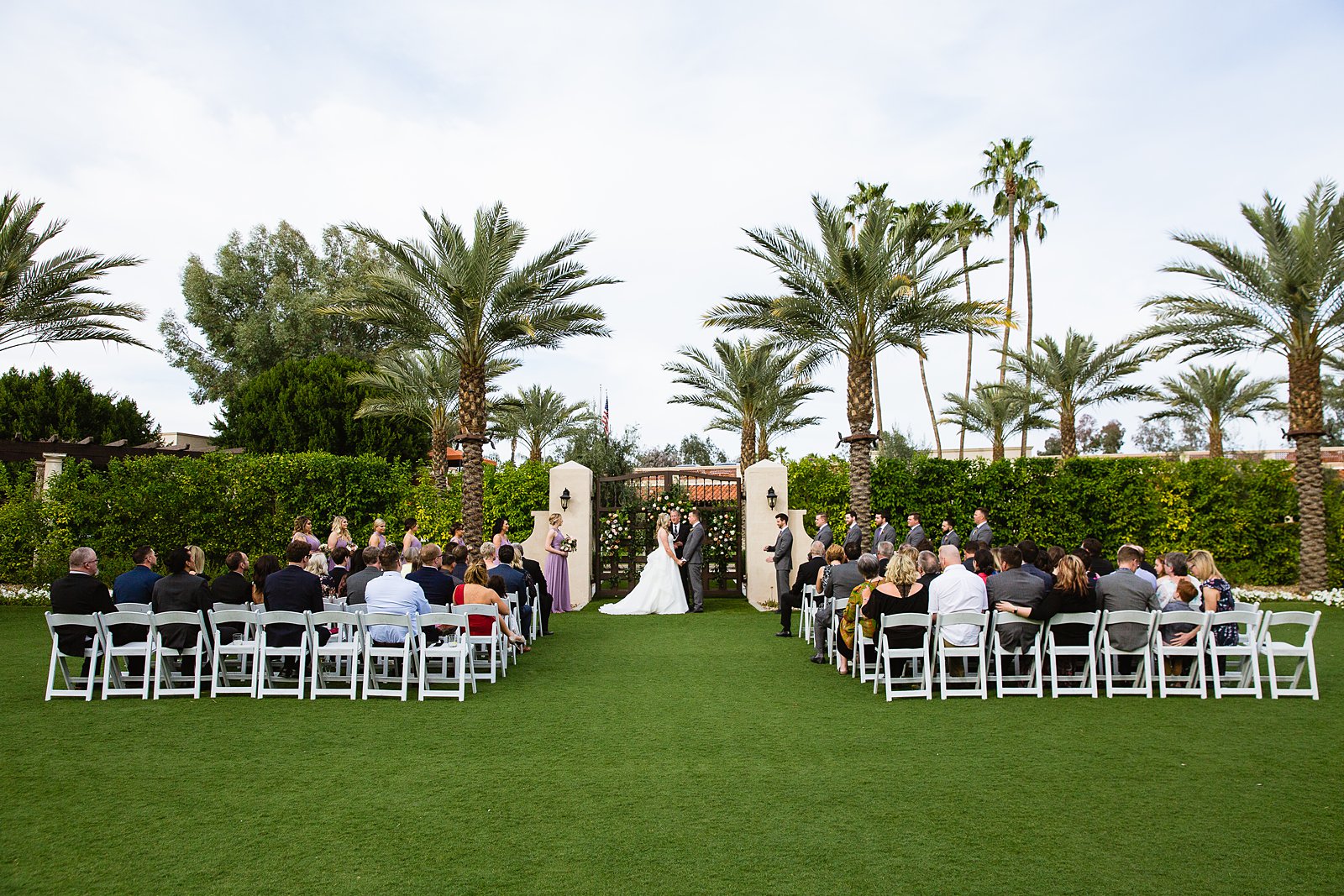 Outdoor spring wedding ceremony at The Scottsdale Resort at McCormick Ranch by Arizona wedding photographer PMA Photography.