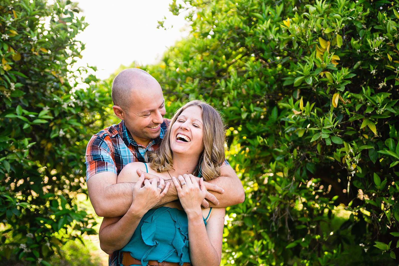 Couple laugh together during their Sahuaro Ranch engagement session by Phoenix engagement photographer PMA Photography.