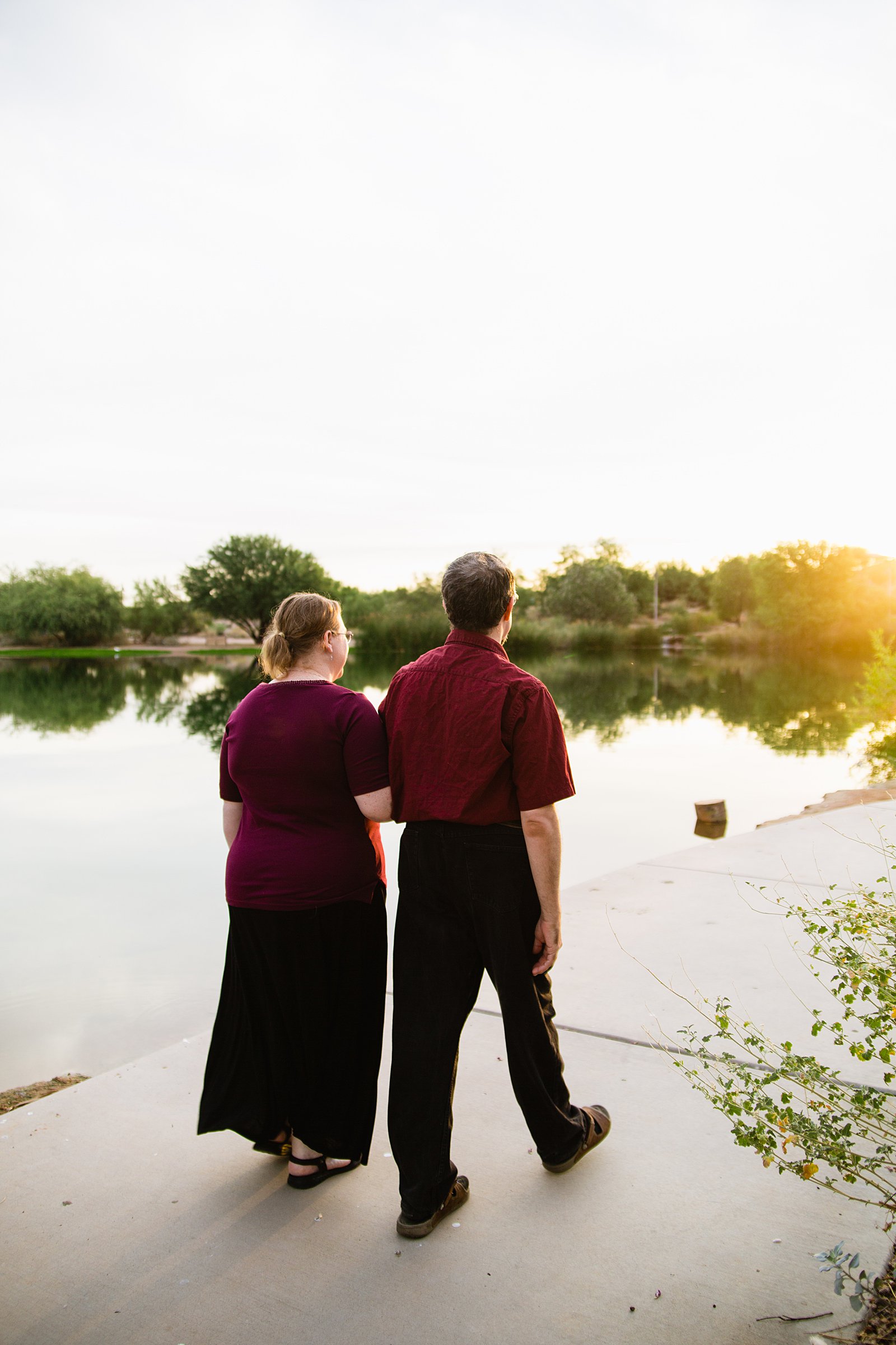 Couple walking together during their Veterans Oasis Park engagement session by Gilbert engagement photographer PMA Photography.