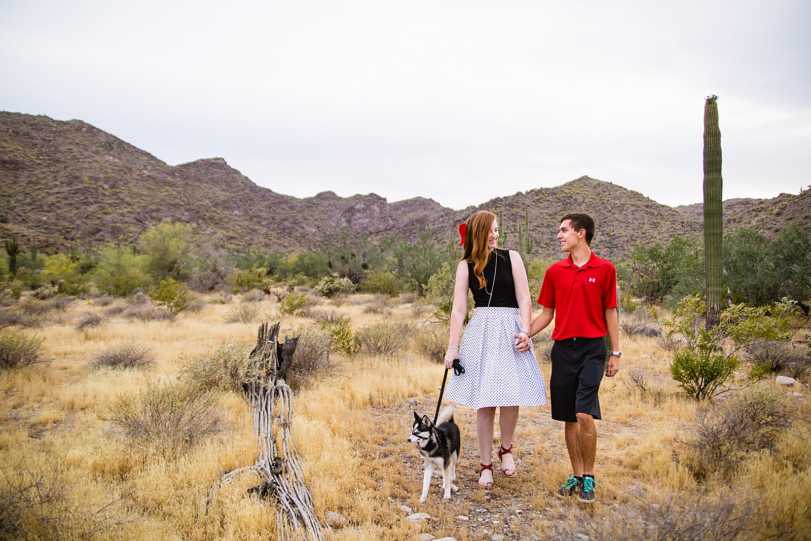 Couple walking together during their White Tanks anniversary session by Phoenix engagement photographer PMA Photography.