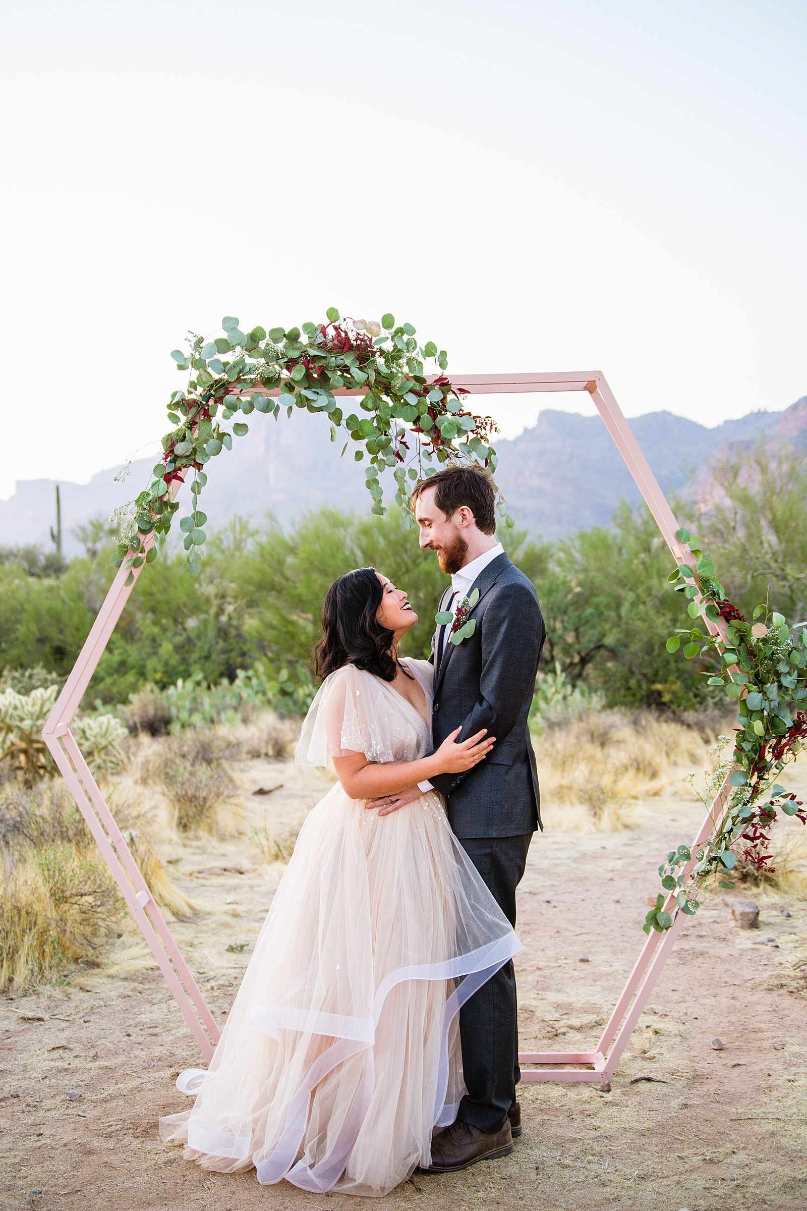 Bride and Groom pose during their Superstition Mountain Cloth and Flame wedding by Arizona wedding photographer PMA Photography.