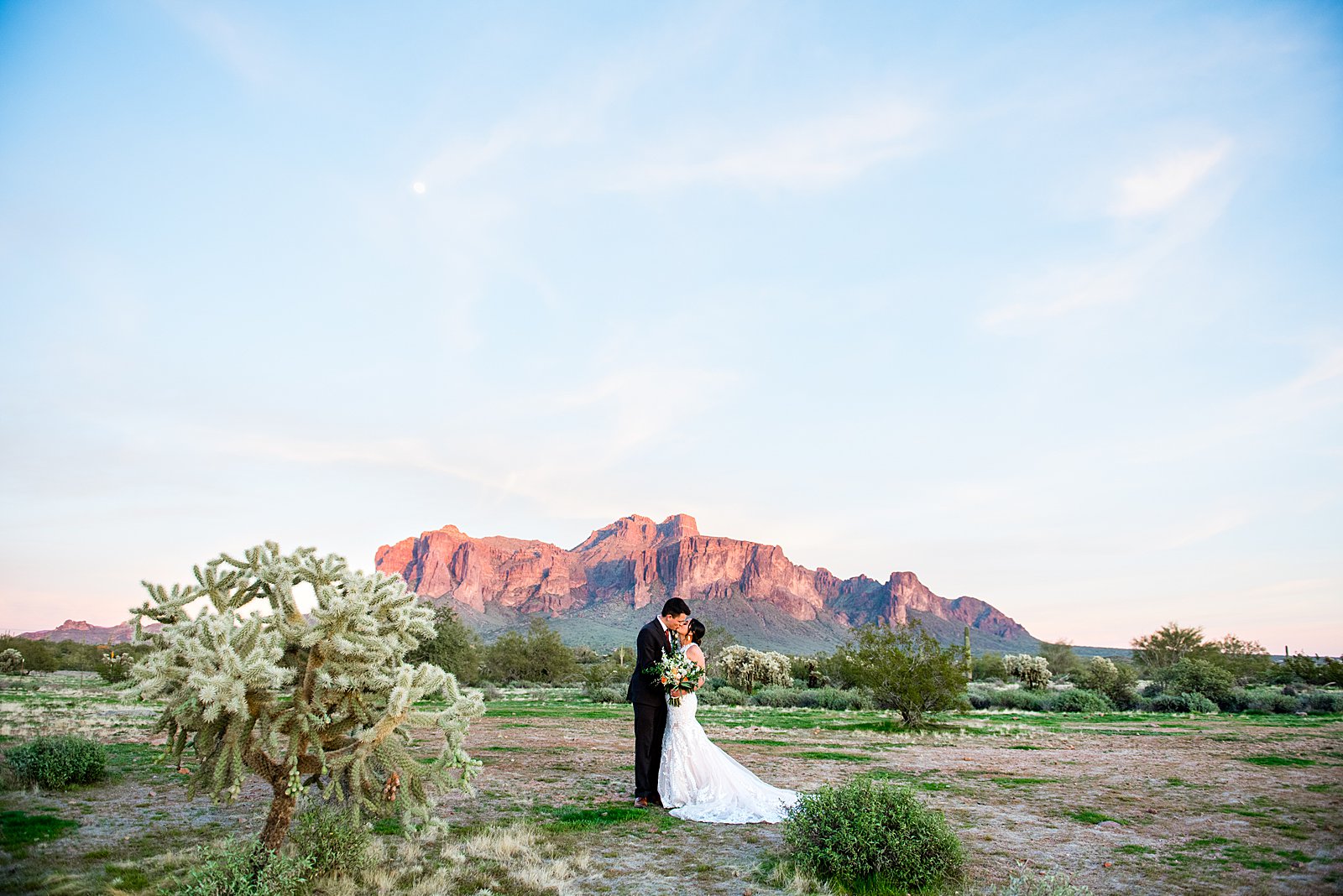 Bride and Groom share a kiss with epic views of the superstition mountains during their The Paseo wedding by Arizona wedding photographer PMA Photography.