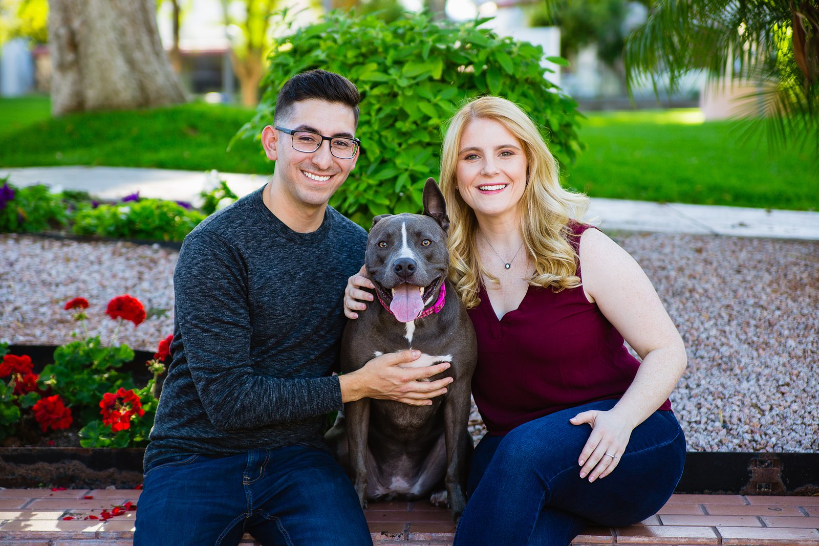 Couple pose with their dog for their engagement session in Scottsdale by PMA Photography