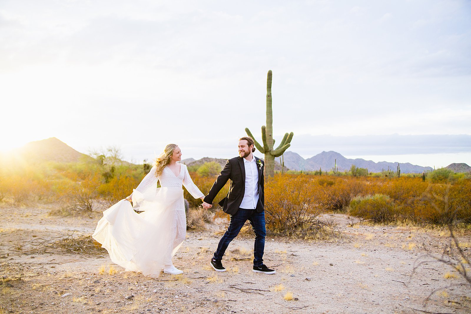 Bride and Groom walking together during their San Tan Regional Park wedding by Arizona wedding photographer PMA Photography.
